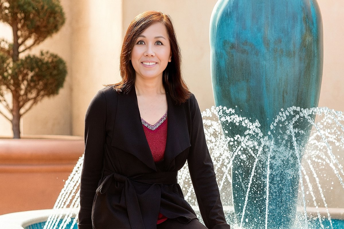Kathy Huang Space Coast real estate agent standing by a fountain in a luxury outdoor setting in Florida